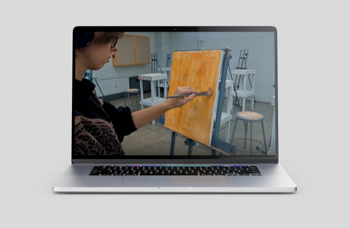Shot from manifesto film of a woman painting on a canvas displayed on a computer screen