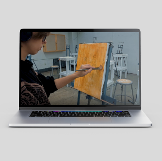 Shot from manifesto film of a woman painting on a canvas displayed on a computer screen